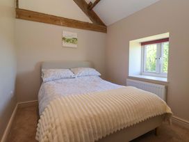 A bedroom with a bed and a window at The Annexe at Dalby Carr