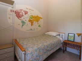 A bedroom with a bed and a world map on the wall at The Annexe at Dalby Carr