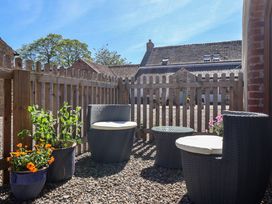 An outdoor seating area with chairs and plants at The Annexe at Dalby Carr