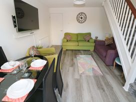 A living room with a sofa and dining area at The Gower Gateway in Gowerton near Swansea