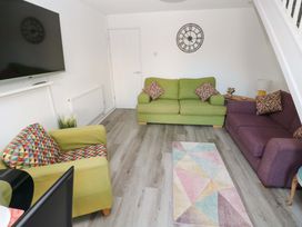 A living room with sofa and armchair at The Gower Gateway in Gowerton near Swansea