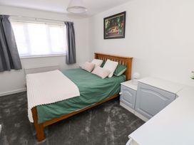 A bedroom with a bed and window at The Gower Gateway in Gowerton near Swansea