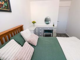 A bedroom with a bed and dresser at The Gower Gateway in Gowerton near Swansea