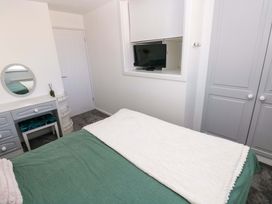A bedroom with a bed and a television at The Gower Gateway in Gowerton near Swansea