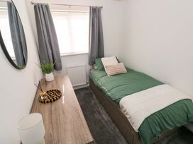 A bedroom with a bed and desk at The Gower Gateway in Gowerton near Swansea