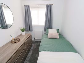 A bedroom with a bed and chest of drawers at The Gower Gateway in Gowerton near Swansea
