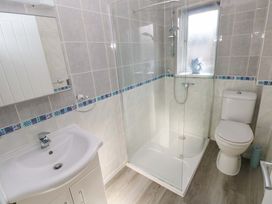 A bathroom with a shower and sink at The Gower Gateway in Gowerton near Swansea
