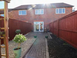 A garden with paved area and flower pots at The Gower Gateway in Gowerton near Swansea
