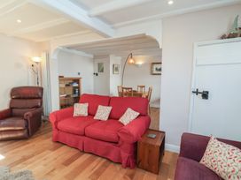 A living room with a sofa and armchair at Fleming Cottage