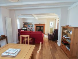 A living room with a fireplace and bookshelf at Fleming Cottage