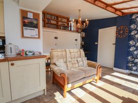 A living room with a sofa and table at Fleming Cottage in 