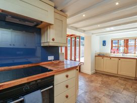 A kitchen with cabinets and appliances at Fleming Cottage