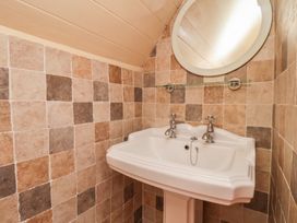 A bathroom with a sink and a mirror at Fleming Cottage 