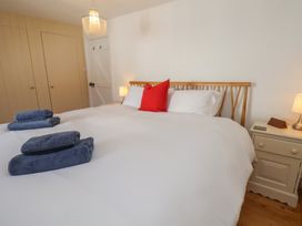 A bedroom with a bed and nightstand at Fleming Cottage