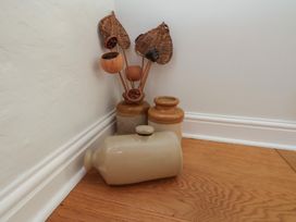 A collection of vases and decorative stems in a corner at Fleming Cottage