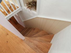 A staircase with wooden steps and a railing at Fleming Cottage 