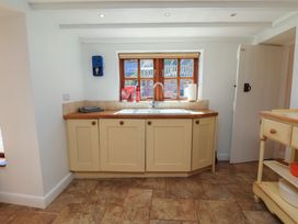 A kitchen with cabinets and a sink at Fleming Cottage