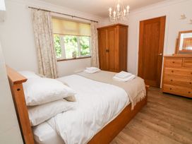 A bedroom with a bed and wardrobe at Tinners Way in Helston