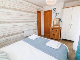 A bedroom with a bed and wardrobe at Tinners Way in Helston