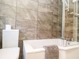 A bathroom with a bathtub and toilet at Tinners Way in Helston