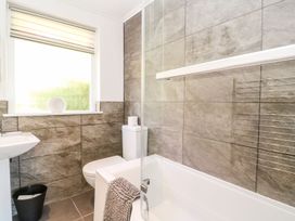 A bathroom with a bathtub and shower at Tinners Way in Helston