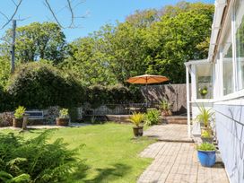 A garden with plants and an umbrella at Tinners Way in Helston