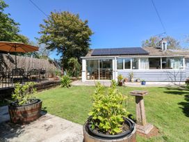 A garden with a table and chairs at Tinners Way Helston