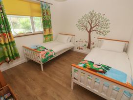 A bedroom with two beds and a tree wall decoration at Tinners Way in Tresowes near Ashton