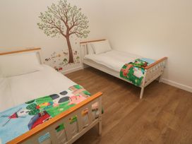A bedroom with two beds and wall art at Tinners Way in Tresowes near Ashton