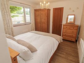 A bedroom with a bed and wooden furniture at Tinners Way in Tresowes near Ashton