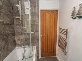 A bathroom with a shower and bathtub at Tinners Way in Tresowes near Ashton