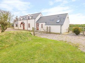 A house with a gate and grassy area at Maerdy Cwtch in Haverfordwest