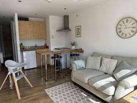 A living room with a dining table and sofa at Dog-friendly lodge, steps to St Ives train, Hayle