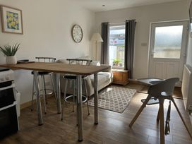 A living room with a sofa and dining table at Dog-friendly lodge, steps to St Ives train, Hayle