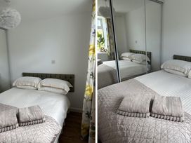 A bedroom with a bed and pillows at Dog-friendly lodge, steps to St Ives train Hayle