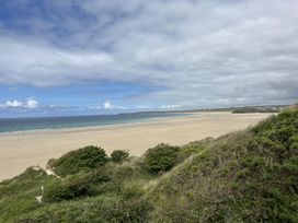 A beach with sand and ocean at Dog-friendly lodge, steps to St Ives train, Hayle