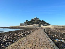 A pathway leading to a castle on a hill at Dog-friendly lodge, steps to St Ives train, Hayle