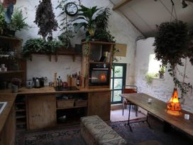A kitchen with wooden furniture and shelves at Hapus Yurt - Two Beautiful Yurts and Barn Cottage