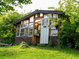 A shed with green surroundings at Hapus Yurt - Two Beautiful Yurts and Barn Cottage