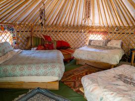An interior of a yurt with beds and decorative items at Hapus Yurt - Two Beautiful Yurts and Barn Cottage