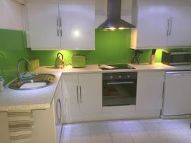 A kitchen with a sink, kettle, oven, and microwave at Zip Cottage Sleeps 2-3 climb snowdon zip world