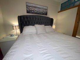 A bedroom with a bed and nightstand at Zip Cottage Sleeps 2-3 climb snowdon zip world