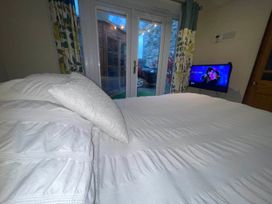 A bedroom with a bed and television at Zip Cottage Sleeps 2-3 climb snowdon zip world