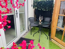 An outdoor seating area with a table and chairs at Zip Cottage Sleeps 2-3 climb snowdon zip world