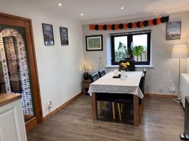 A dining room with a table and chairs at Cottage with mountain and sea views, Anglesey
