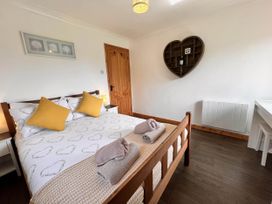 A bedroom with a bed and decor at Cottage with mountain and sea views, Anglesey