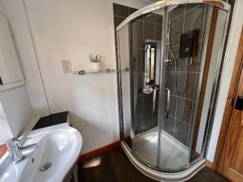 A bathroom with a shower and sink at Cottage with mountain and sea views, Anglesey