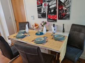 A dining room setup with a table and chairs at Riverside cottage with otters near Tintagel