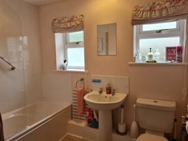 A bathroom featuring a bathtub, sink, and toilet at Riverside cottage with otters near Tintagel