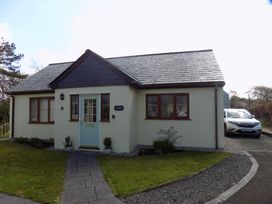 A house with a pathway and car at Riverside cottage with otters near Tintagel
